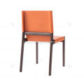 Orange saddle leather armless dining chairs